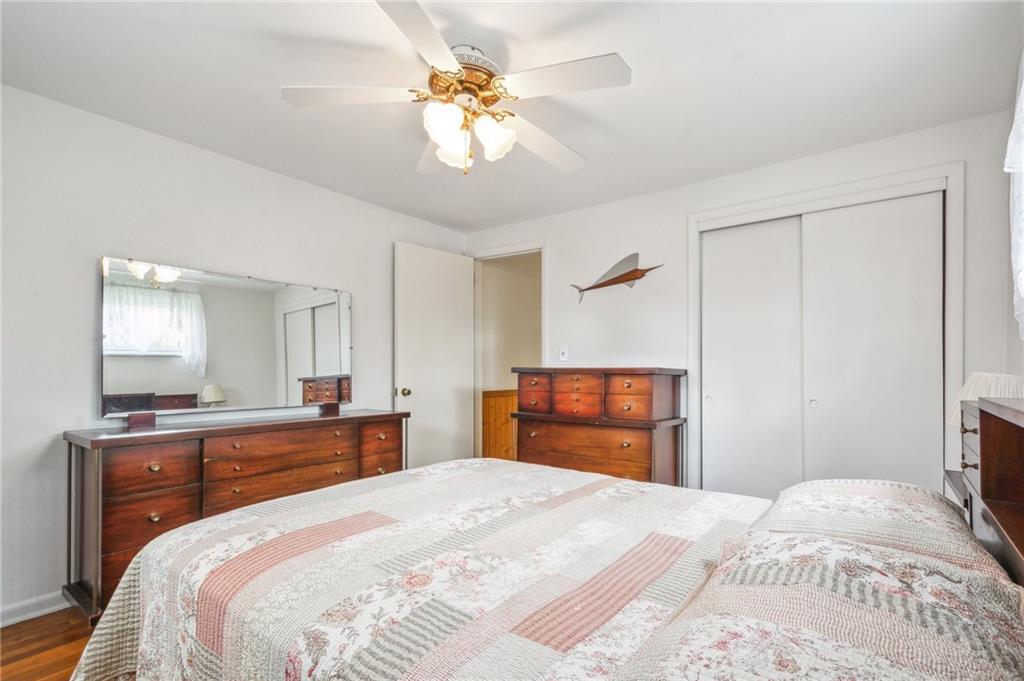 203 Oak Road Pittsburgh, PA 15239 - Photo 18 of 32 a bedroom with a bed and a chandelier