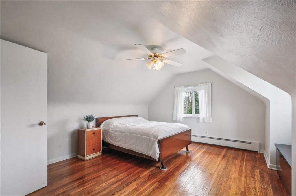 203 Oak Road Pittsburgh, PA 15239 - Photo 23 of 32 a bedroom with a bed and a window