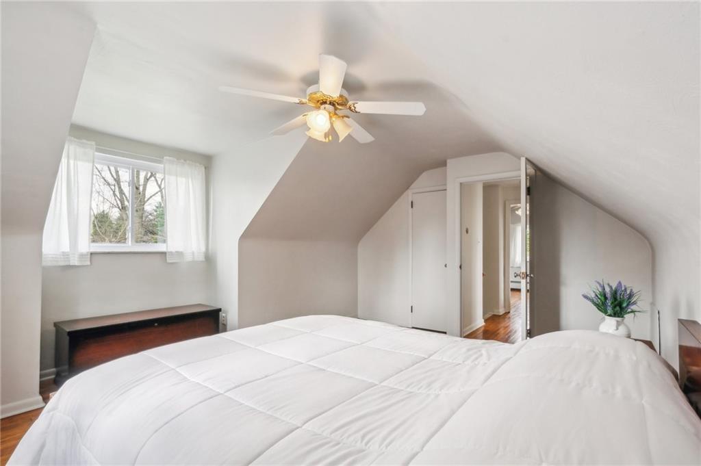 203 Oak Road Pittsburgh, PA 15239 - Photo 24 of 32 a bedroom with a bed chandelier and a window
