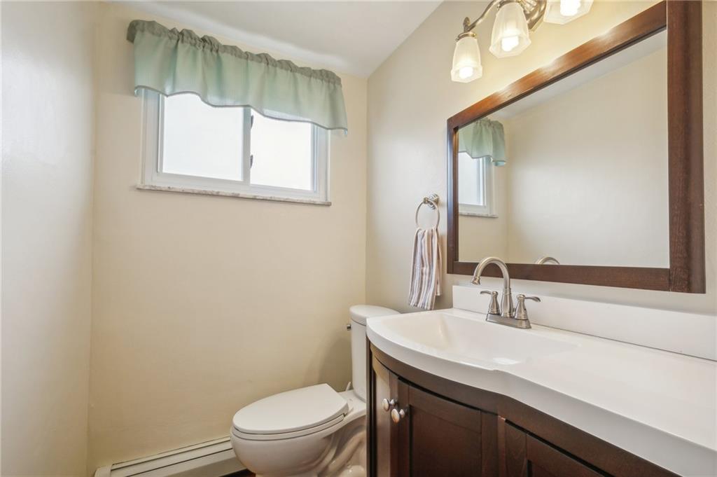 203 Oak Road Pittsburgh, PA 15239 - Photo 25 of 32 a bathroom with a toilet a sink and mirror