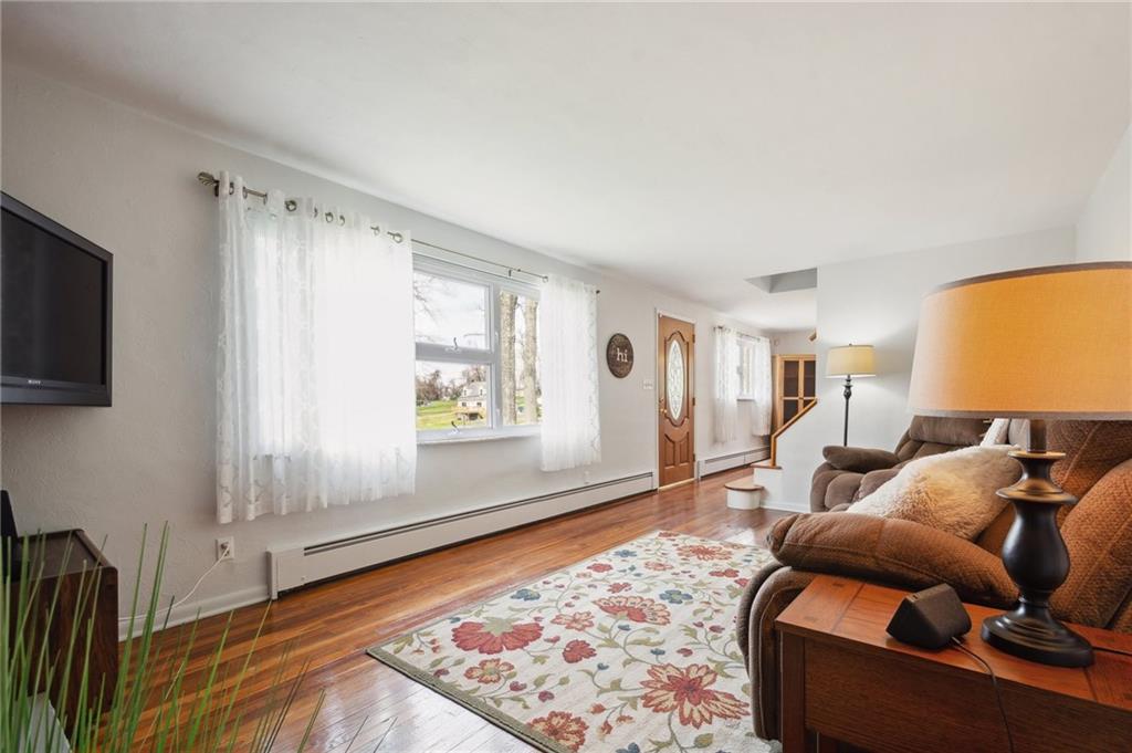 203 Oak Road Pittsburgh, PA 15239 - Photo 8 of 32 a living room with furniture and a rug