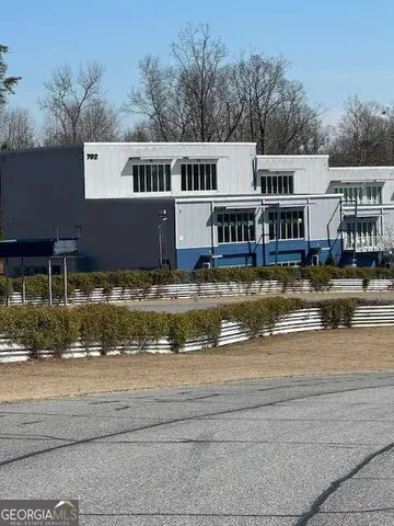 a front view of a house with swimming pool and a yard