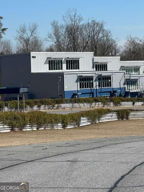 a front view of a house with swimming pool and a yard