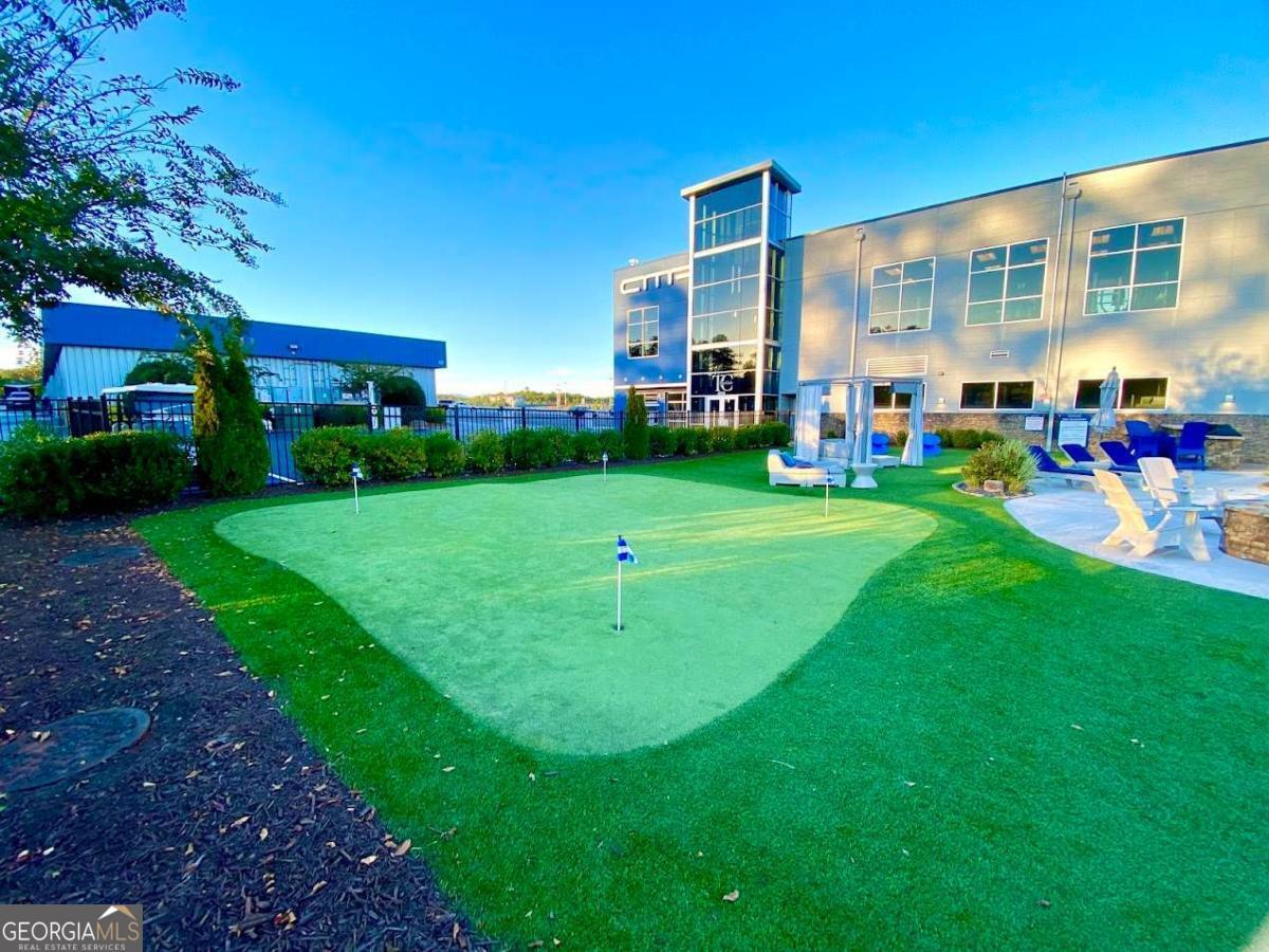 702 Joe Lane Cox Road, Unit 101 Dawsonville, GA 30534 - Photo 22 of 28 a view of a house with a backyard