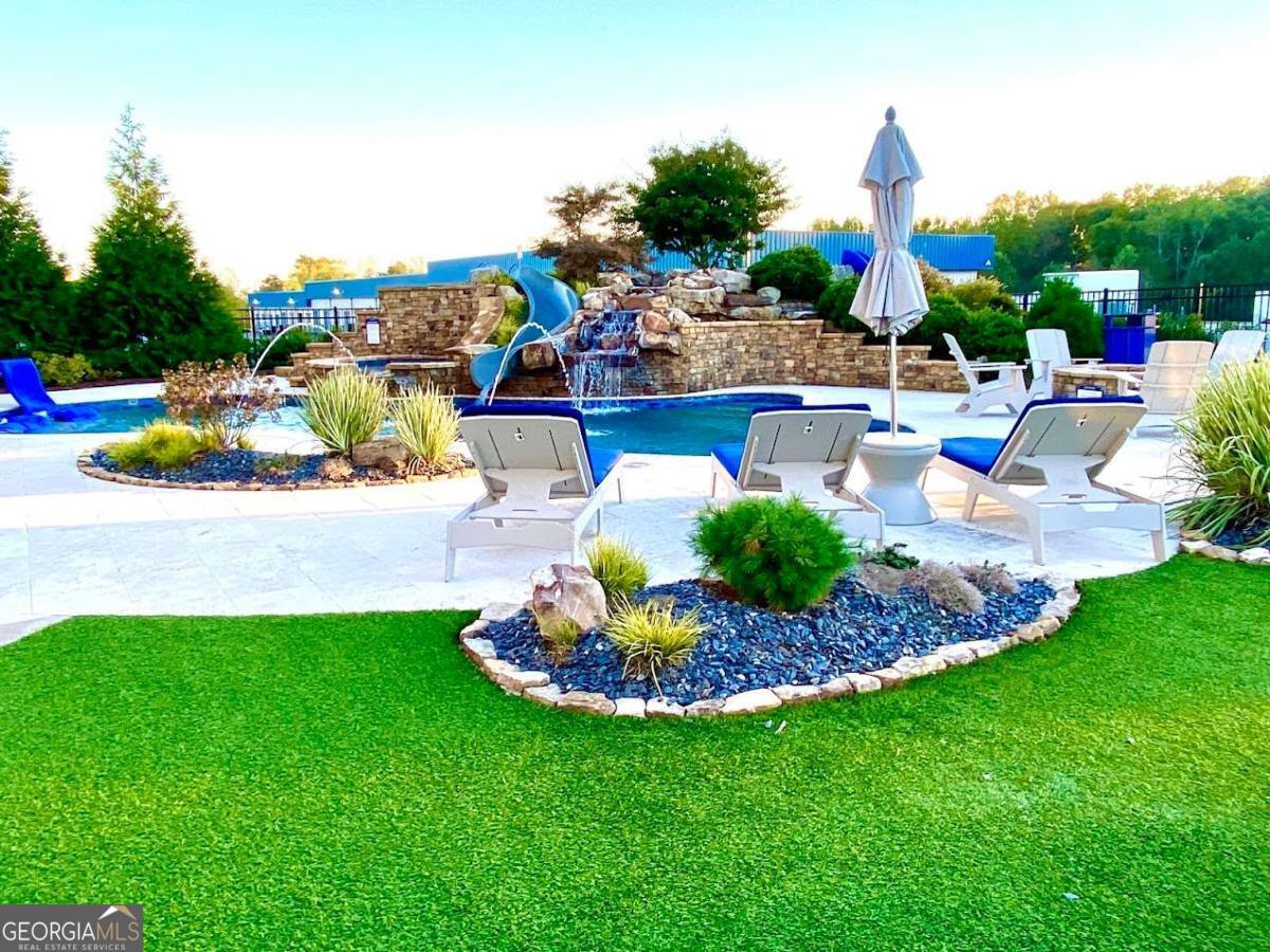 702 Joe Lane Cox Road, Unit 101 Dawsonville, GA 30534 - Photo 28 of 28 a view of a backyard with plants and patio