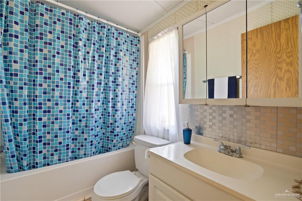 27516 Glenview Road Rio Hondo, TX 78583 - Photo 14 of 26 Full bath featuring tasteful backsplash, shower / tub combo, and vanity