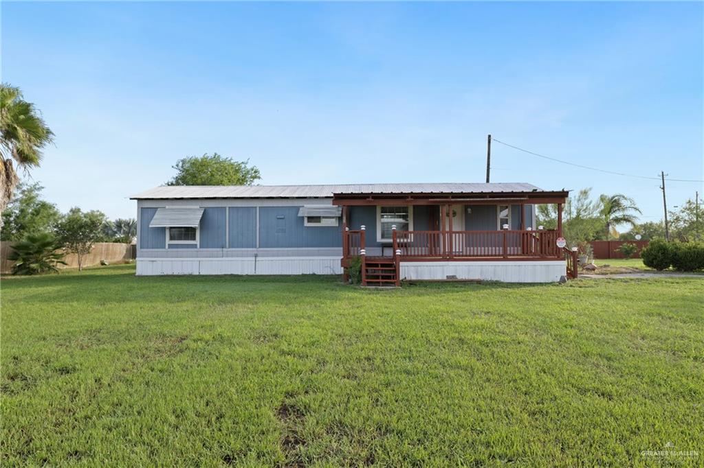 27516 Glenview Road Rio Hondo, TX 78583 - Photo 2 of 26 Manufactured / mobile home featuring covered porch and a front yard