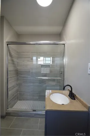 a bathroom with a granite countertop sink and mirror
