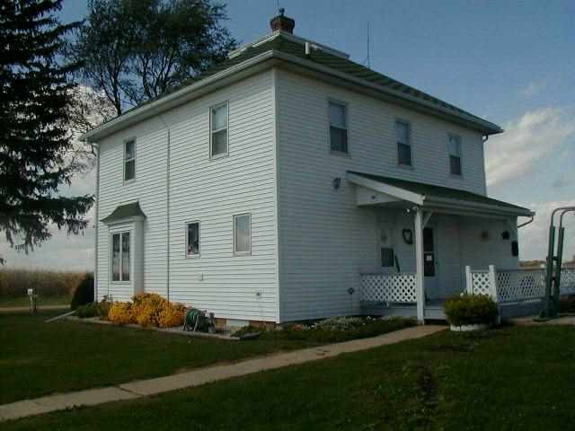 3077 Oakville Road Chadwick, IL 61014 - Photo 2 of 7 a front view of a house with a garden