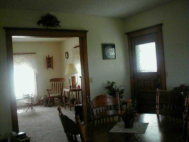 3077 Oakville Road Chadwick, IL 61014 - Photo 6 of 7 a view of a hallway to a livingroom with furniture
