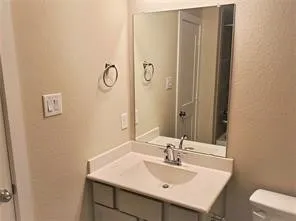 a bathroom with a sink vanity and a mirror