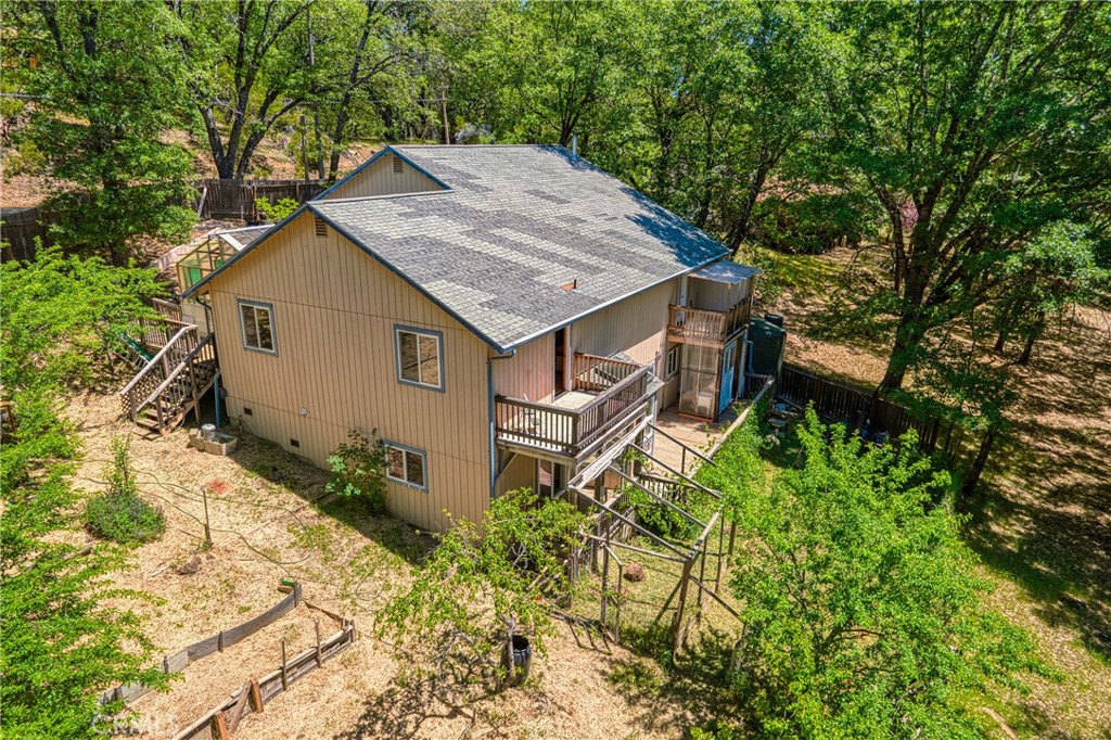 an aerial view of a house with yard and sitting area
