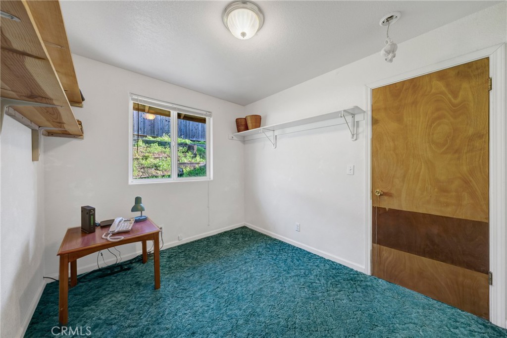 11575 Loch Lomond Road Middletown, CA 95461 - Photo 13 of 38 a room that has a dresser and a window