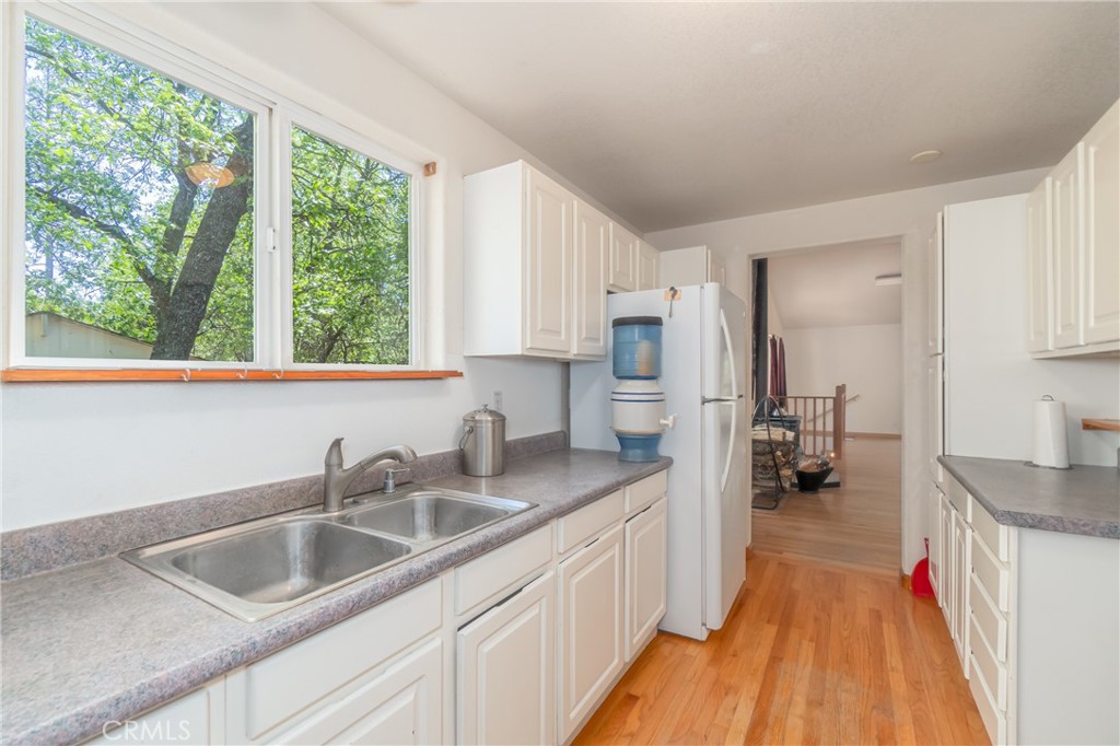 11575 Loch Lomond Road Middletown, CA 95461 - Photo 15 of 38 a kitchen with a sink a counter top space stainless steel appliances a large window and a kitchen counter space