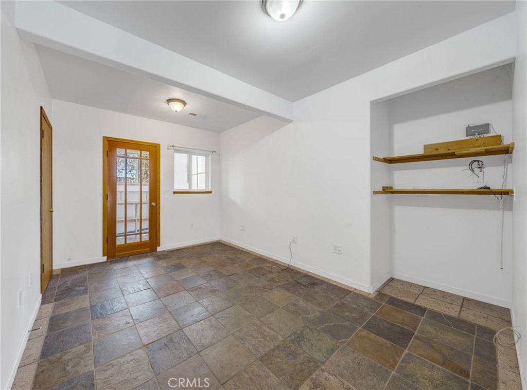 11575 Loch Lomond Road Middletown, CA 95461 - Photo 19 of 38 a view of an empty room with window and cabinet