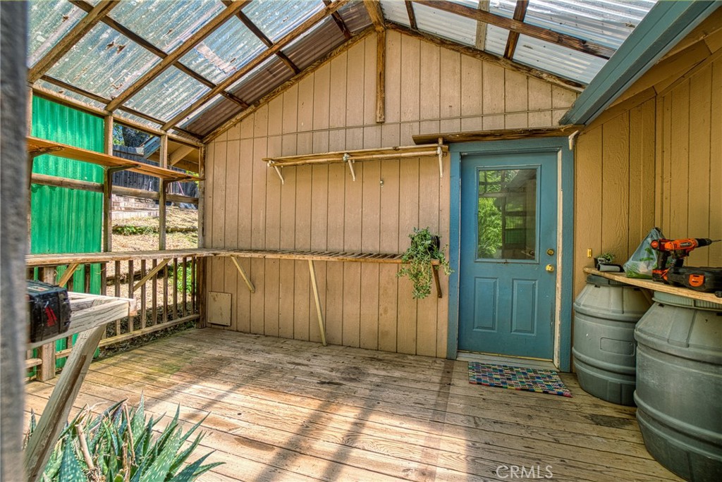 11575 Loch Lomond Road Middletown, CA 95461 - Photo 8 of 38 a view of a porch with wooden floor and iron stairs