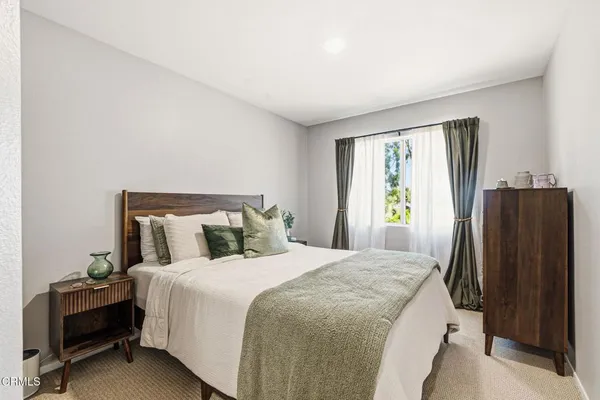 a bedroom with a bed and a dresser