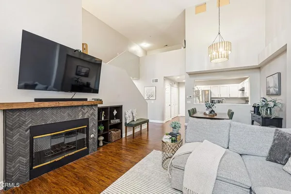a living room with furniture a flat screen tv and a fireplace