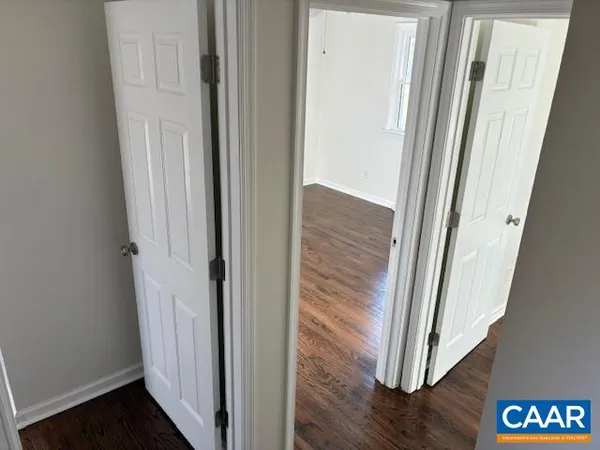 a view of a hallway with wooden floor