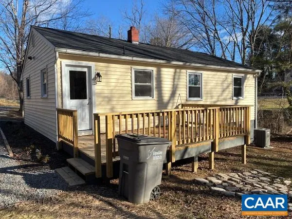 a view of a house with a yard and furniture