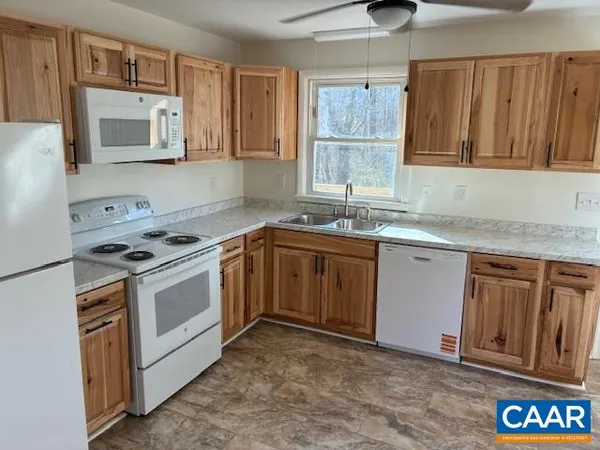 a kitchen with stainless steel appliances granite countertop a sink stove and microwave