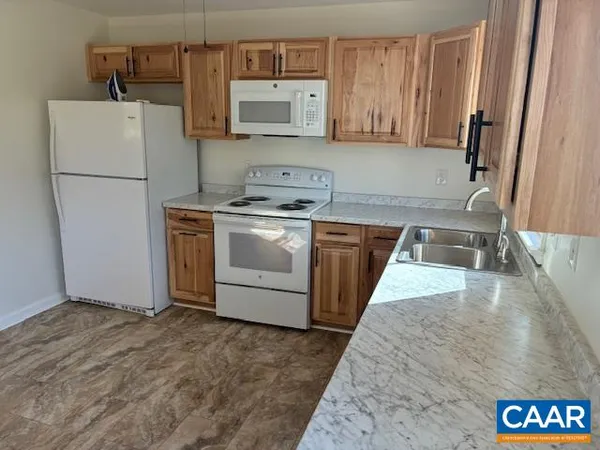 a kitchen with a refrigerator sink and stove