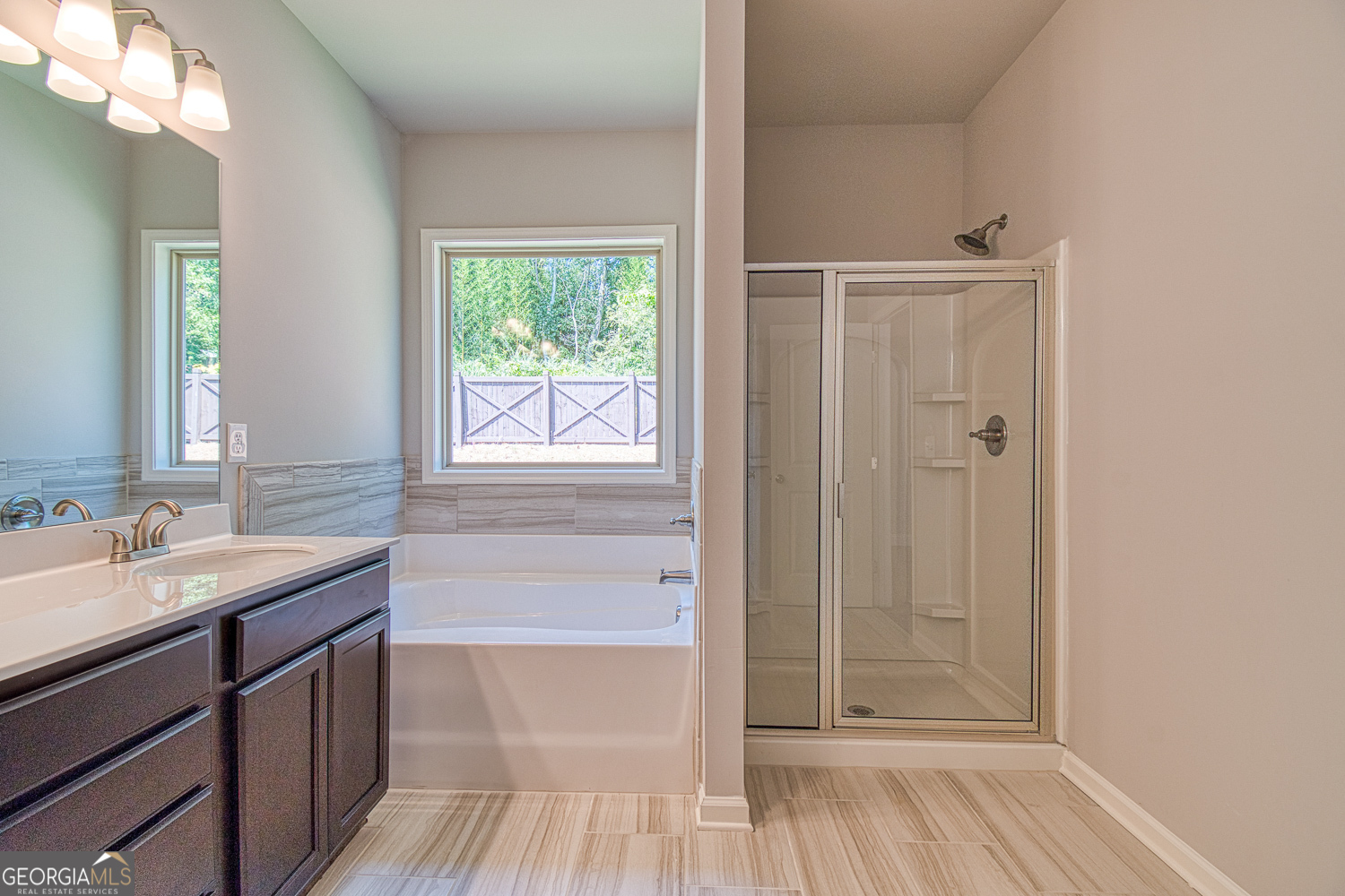 181 Depot Landing Road, Unit 28A Auburn, GA 30011 - Photo 19 of 29 a bathroom with a sink a mirror and a bathtub