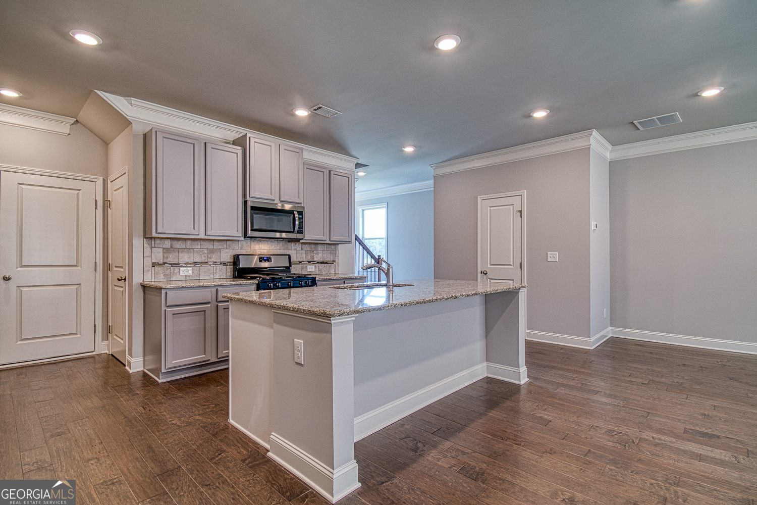 181 Depot Landing Road, Unit 28A Auburn, GA 30011 - Photo 5 of 29 a kitchen with white cabinets and stainless steel appliances