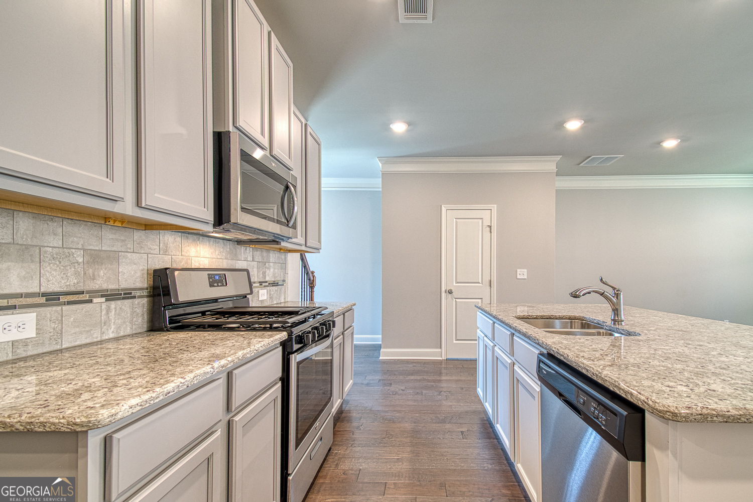 181 Depot Landing Road, Unit 28A Auburn, GA 30011 - Photo 6 of 29 a kitchen with stainless steel appliances granite countertop a sink stove and cabinets