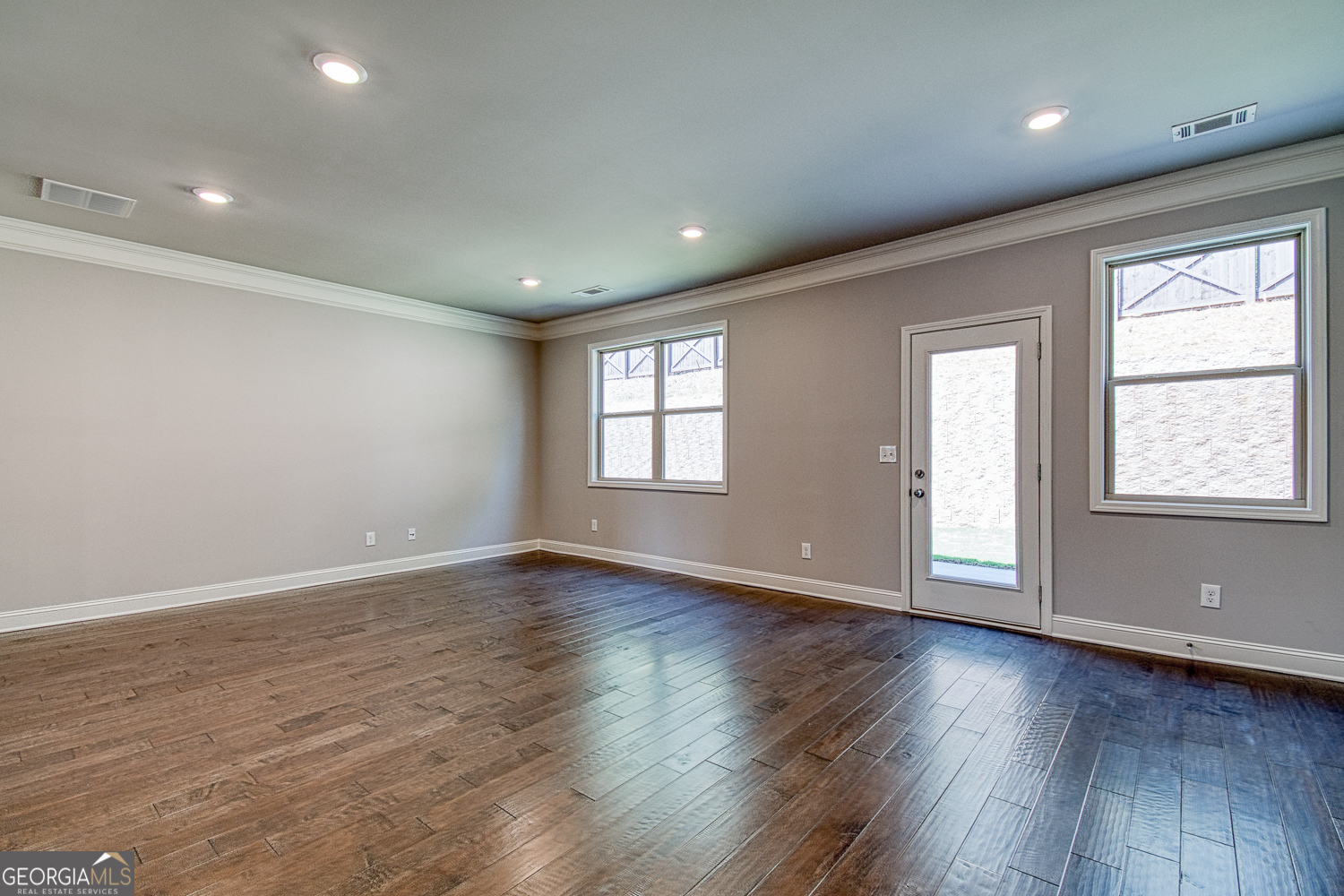 181 Depot Landing Road, Unit 28A Auburn, GA 30011 - Photo 8 of 29 a view of an empty room with wooden floor and a window