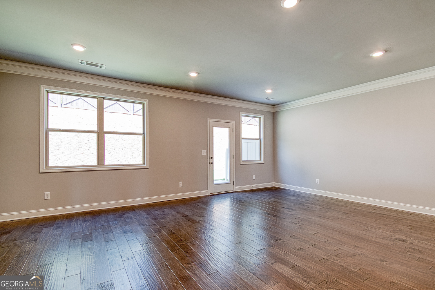 181 Depot Landing Road, Unit 28A Auburn, GA 30011 - Photo 10 of 29 an empty room with wooden floor and windows