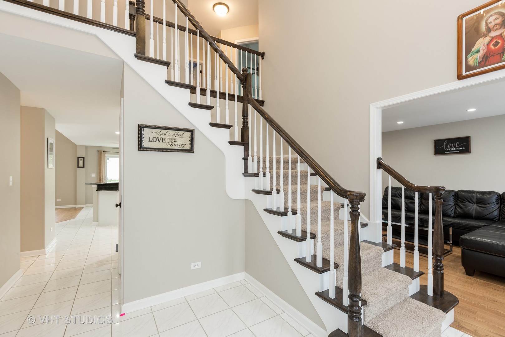 2112 Wicklow Road Naperville, IL 60564 - Photo 2 of 17 a view of staircase with lots of frames and couches