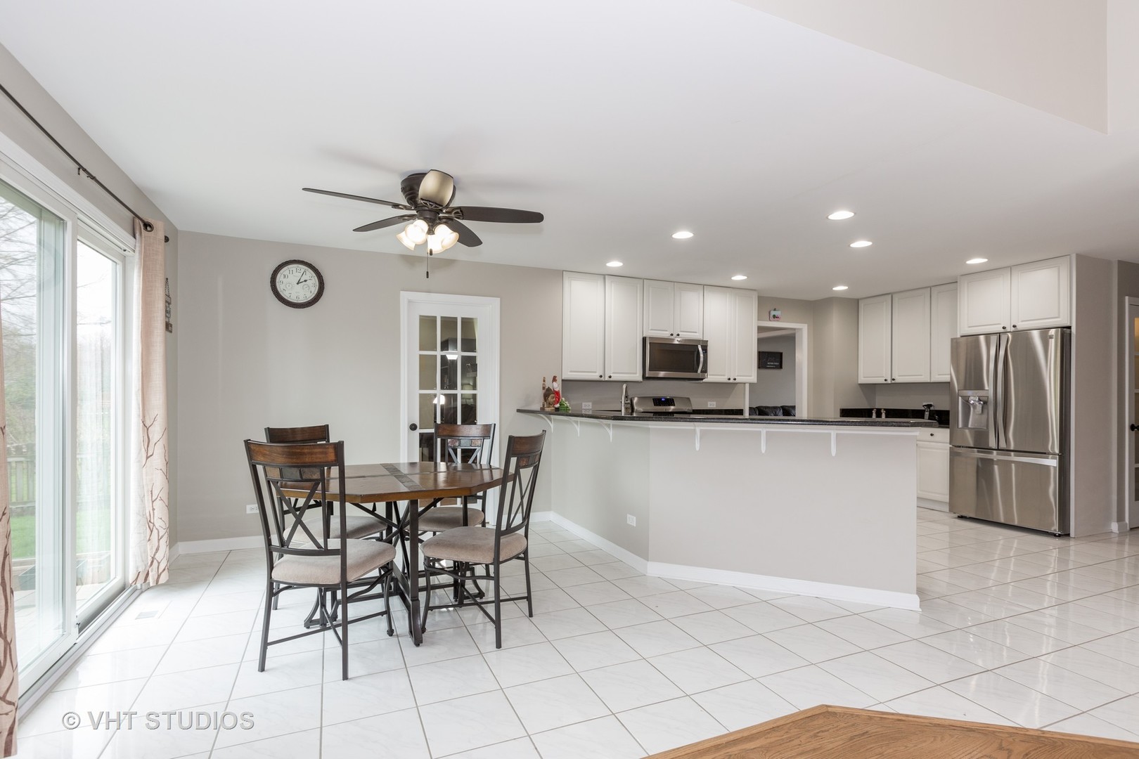 2112 Wicklow Road Naperville, IL 60564 - Photo 4 of 17 a view of kitchen with stainless steel appliances granite countertop dining table chairs and a window