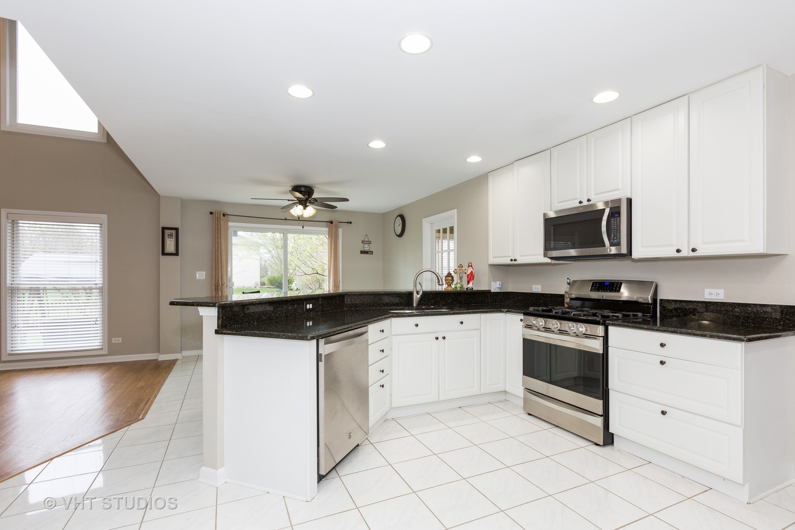 2112 Wicklow Road Naperville, IL 60564 - Photo 5 of 17 a kitchen with granite countertop a sink and white cabinets