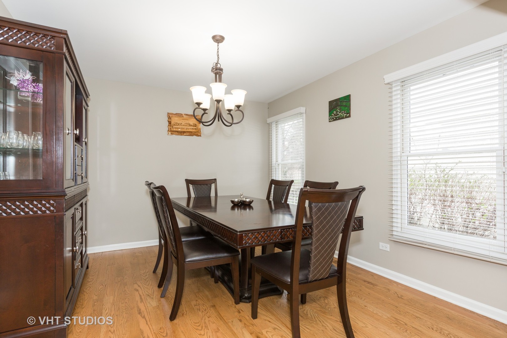 2112 Wicklow Road Naperville, IL 60564 - Photo 6 of 17 a view of a dining room with furniture a chandelier and wooden floor