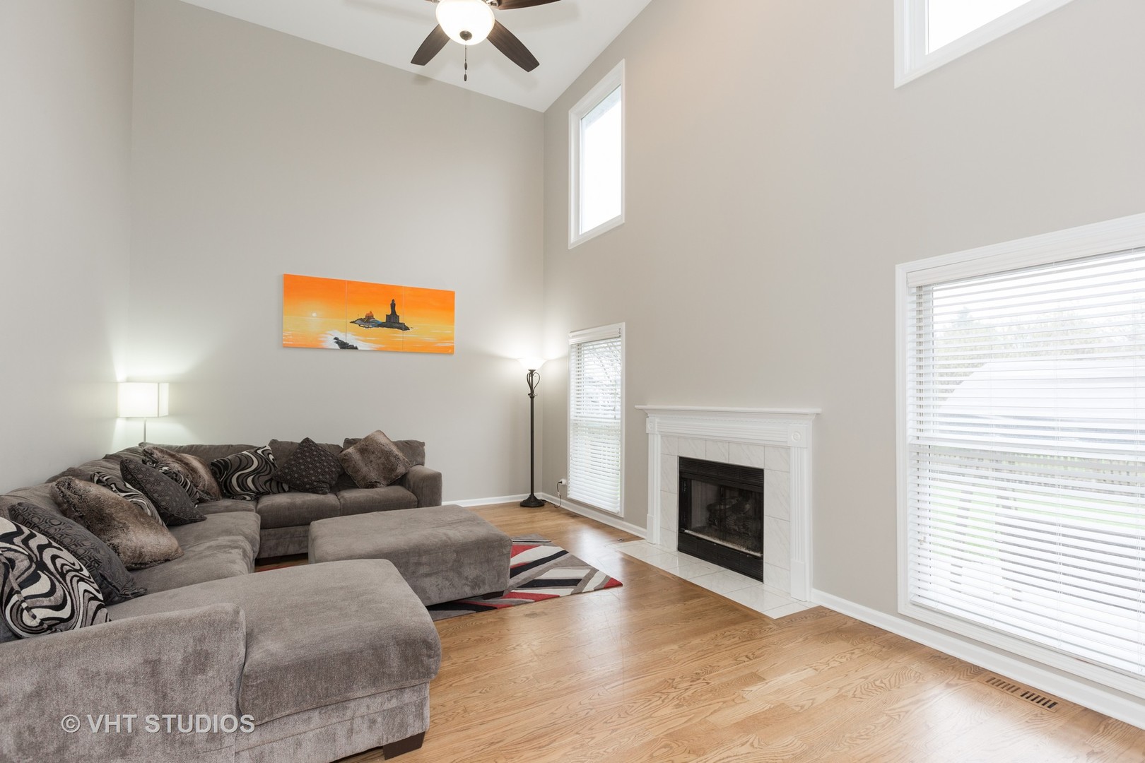 2112 Wicklow Road Naperville, IL 60564 - Photo 7 of 17 a living room with furniture a fireplace and a flat screen tv