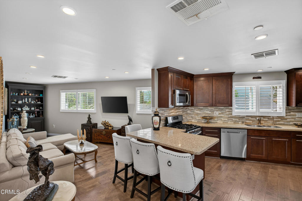 9325 La Shell Drive Tujunga, CA 91042 - Photo 33 of 46 a kitchen with a dining table and chairs