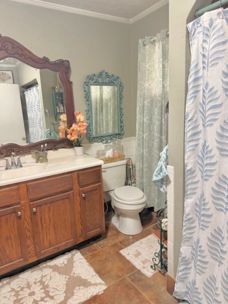 829 North Perkins Road Memphis, TN 38122 - Photo 15 of 36 Full bathroom with vanity, a shower with shower curtain, ornamental molding, and tile walls