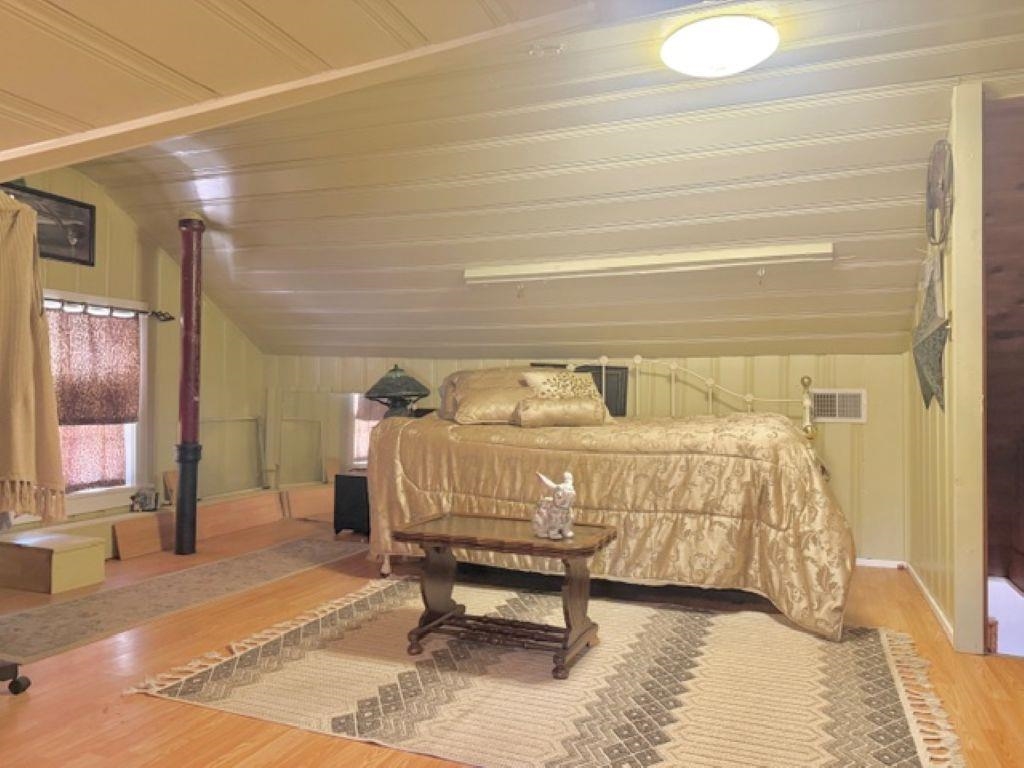 829 North Perkins Road Memphis, TN 38122 - Photo 19 of 36 Bedroom with lofted ceiling and wood finished floors