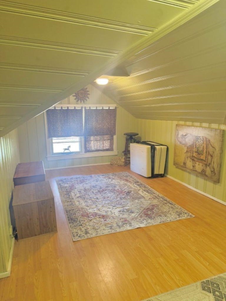 829 North Perkins Road Memphis, TN 38122 - Photo 20 of 36 Bonus room featuring vaulted ceiling, light wood finished floors, and wood walls