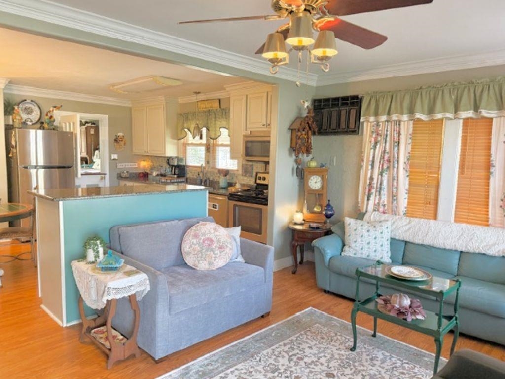 829 North Perkins Road Memphis, TN 38122 - Photo 3 of 36 Living area with ornamental molding, light wood-style floors, and a ceiling fan