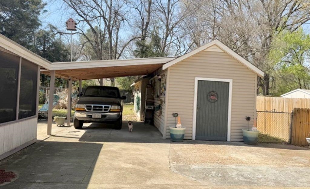 829 North Perkins Road Memphis, TN 38122 - Photo 32 of 36 View of parking featuring concrete driveway and a carport