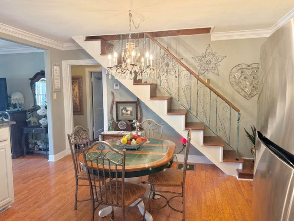 829 North Perkins Road Memphis, TN 38122 - Photo 7 of 36 Dining room featuring crown molding, a chandelier, and light wood-style floors