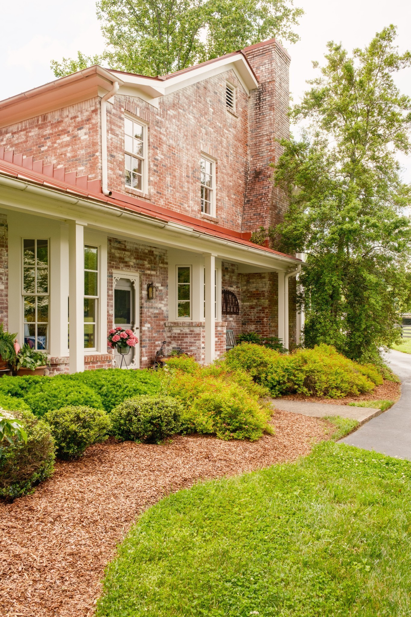 5620 Leipers Creek Road Franklin, TN 37064 - Photo 26 of 74 a view of a white house with a large windows and plants
