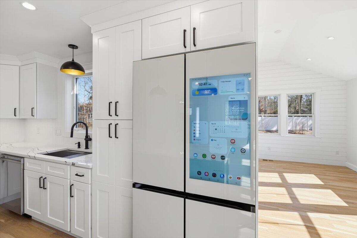 58 Old Chatham Road Brewster, MA 02631 - Photo 12 of 43 a kitchen with stainless steel appliances granite countertop a refrigerator and a sink
