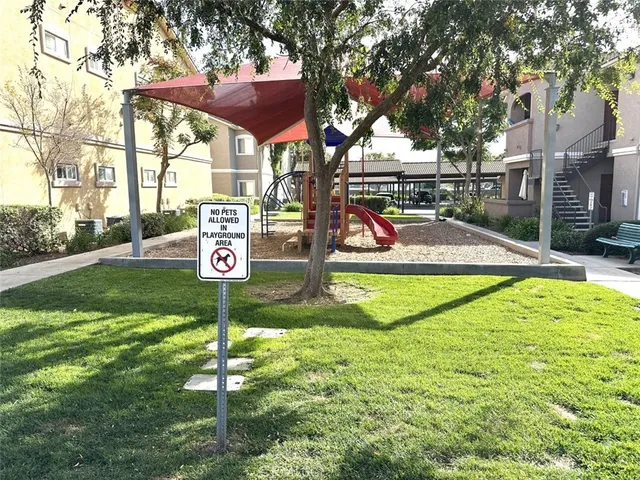a street sign on a sidewalk next to a road