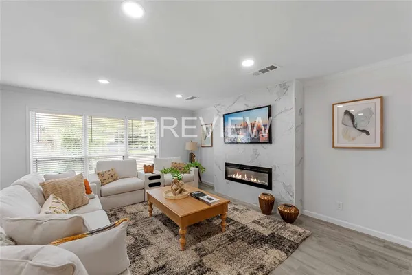 a living room with furniture a rug and a window