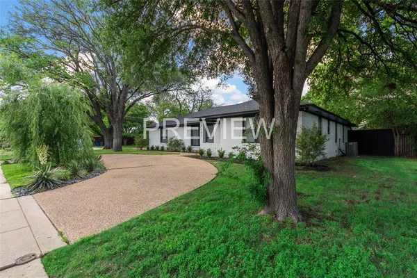a house with green field in front of it