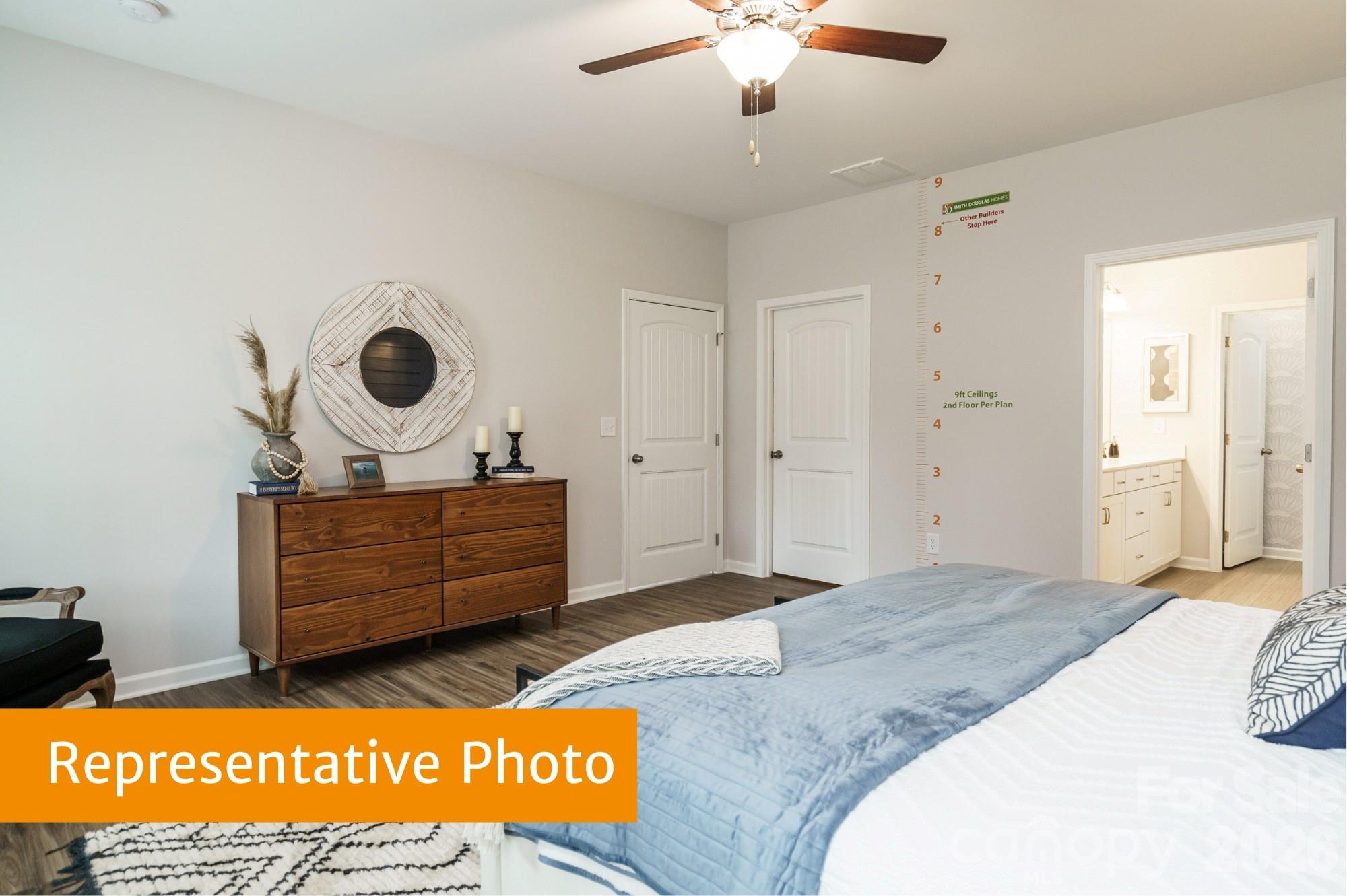 443 Blue Mountain Road Salisbury, NC 28147 - Photo 13 of 21 a bed room with a bed and a chandelier