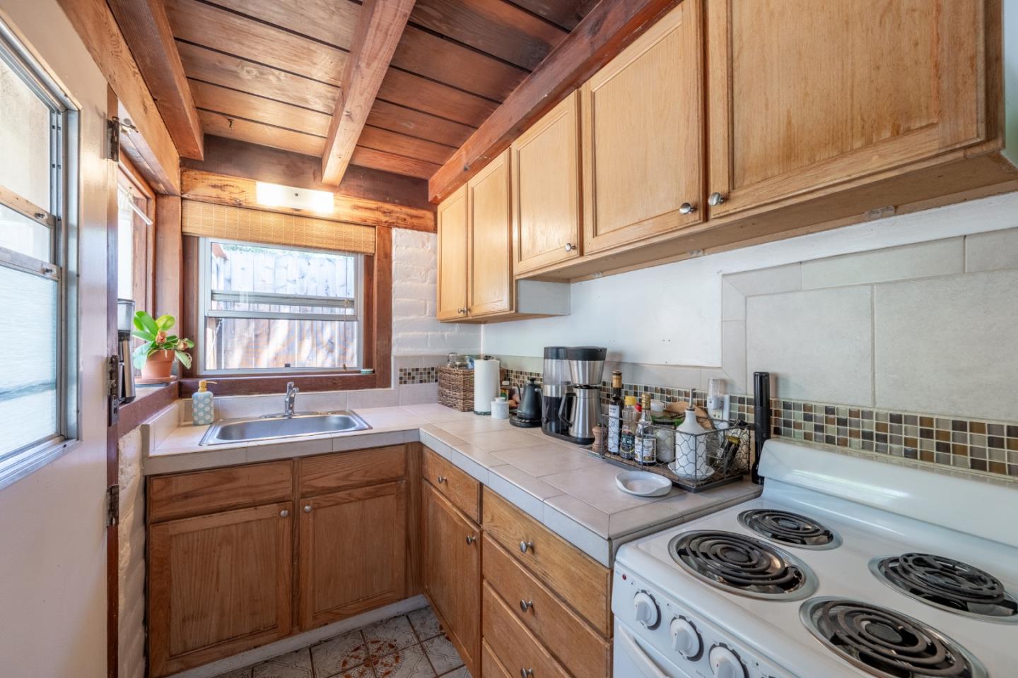 72 Los Laureles Grade Road Carmel Valley, CA 93924 - Photo 36 of 43 a kitchen with a sink stove and cabinets